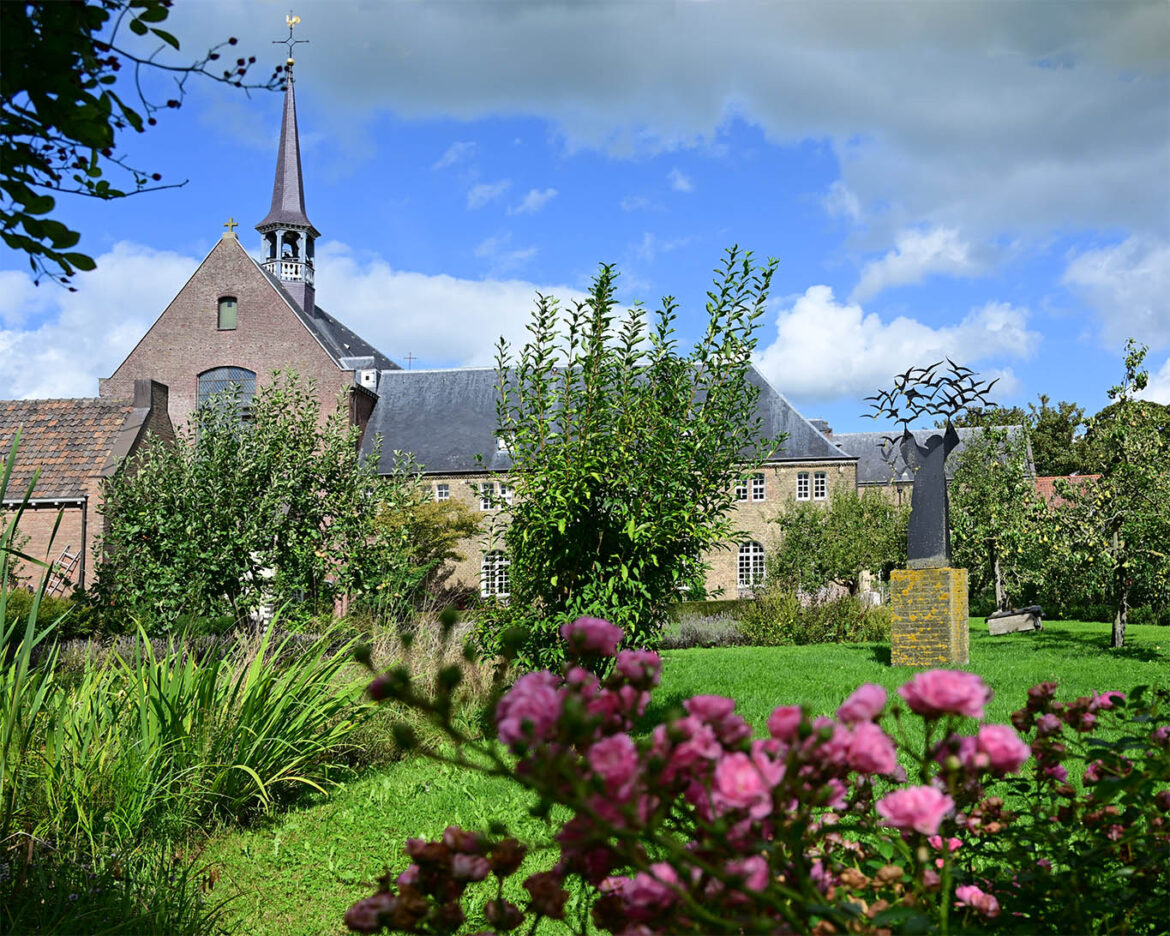 Kloster der Minderbroeders in Megen von der Ostseite vom Garten aus betrachtet. IM Vordergrund die stählerne Plastik des Heiligen Franziskus vom holländischen Künstler Frederick Franck.